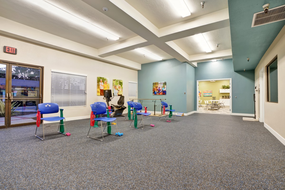A modern fitness area with exercise equipment and colorful decor.