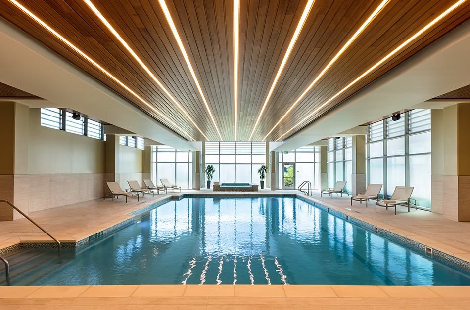 A luxurious indoor swimming pool with modern architectural design and elegant lighting.