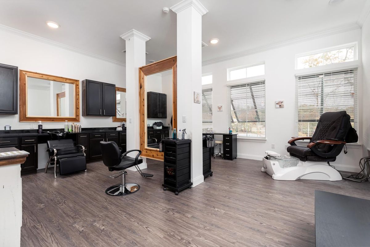 A modern salon interior with mirrors, chairs, and stylish decor.