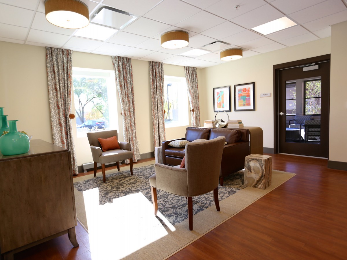 A cozy and well-lit living room with comfortable seating and elegant decor.