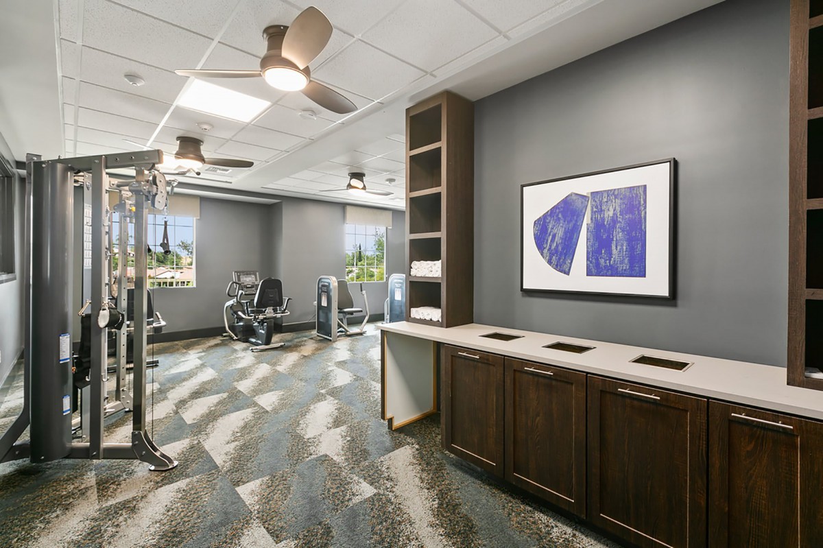 A well-lit gym with exercise equipment and modern decor.
