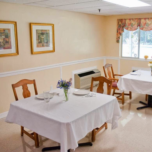 A cozy dining area featuring neatly set tables and warm, inviting decor.