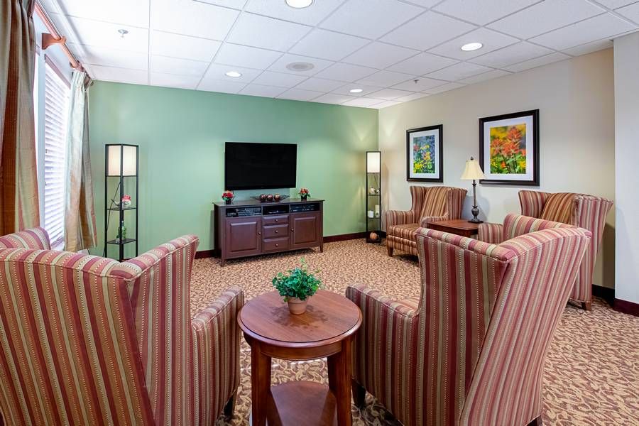 A cozy living room with a television and comfortable seating arrangement.