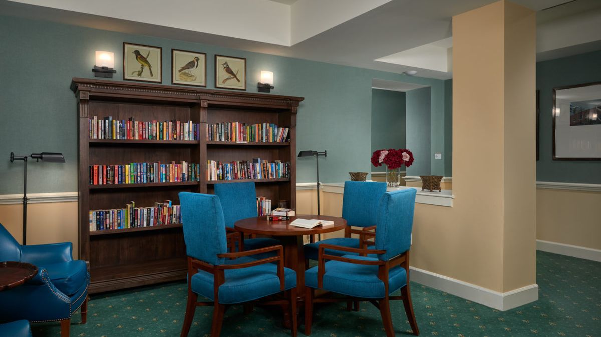 A cozy library nook with a bookshelf and seating area for reading.