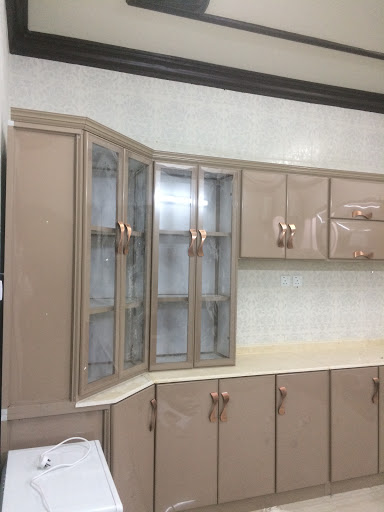 A modern kitchen featuring elegant cabinets with glass doors.