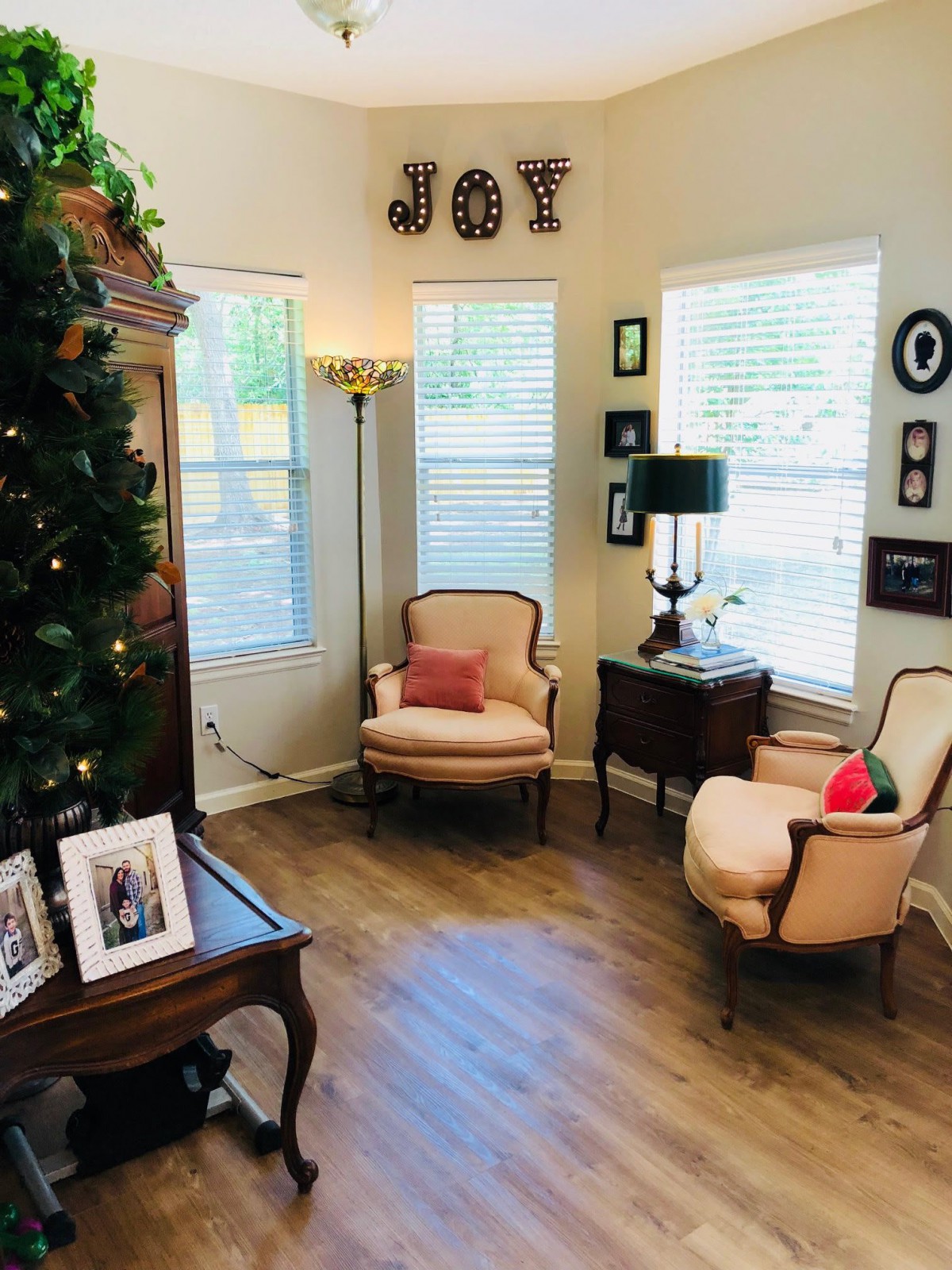 A cozy living room corner with elegant chairs and festive decor.