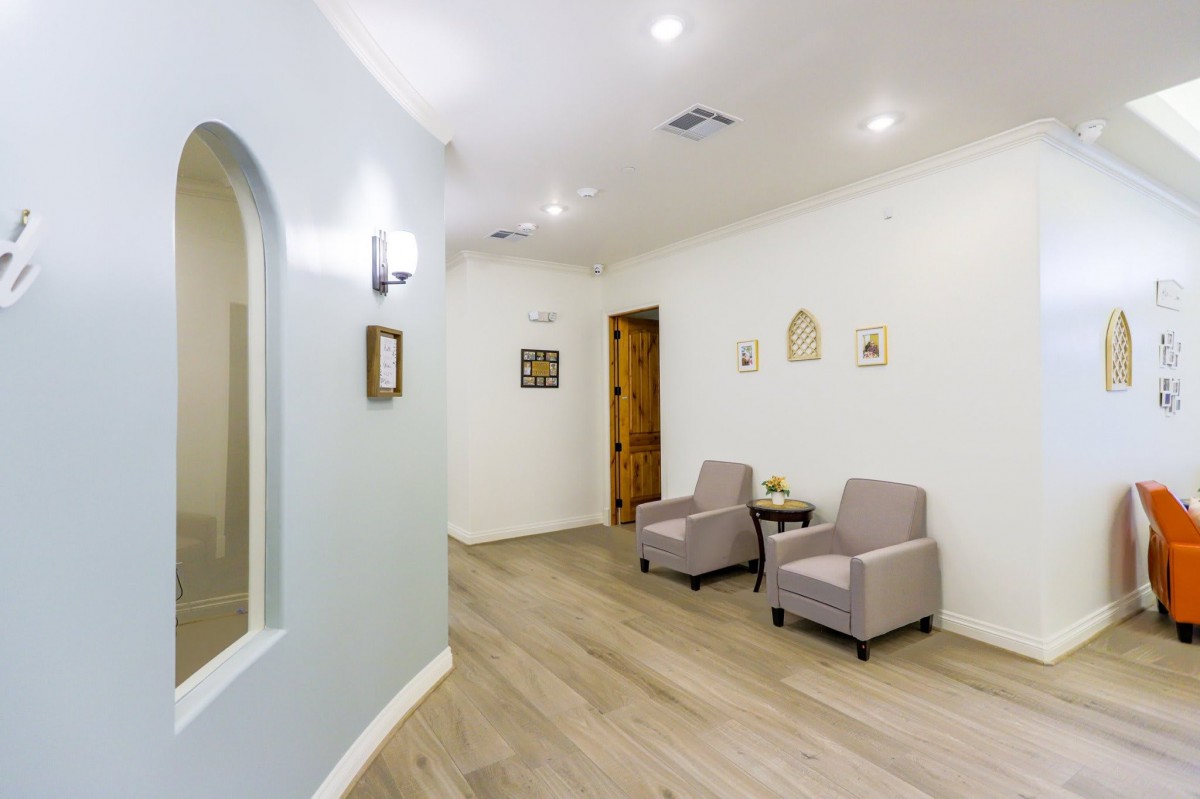 A modern and minimalist waiting area with comfortable chairs, soft lighting, and tasteful decor.
