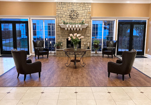 A cozy living room setup featuring elegant seating and a stylish fireplace.
