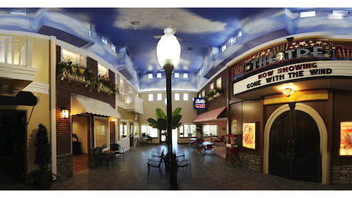 A beautifully designed indoor shopping area featuring a decorative ceiling and inviting seating.