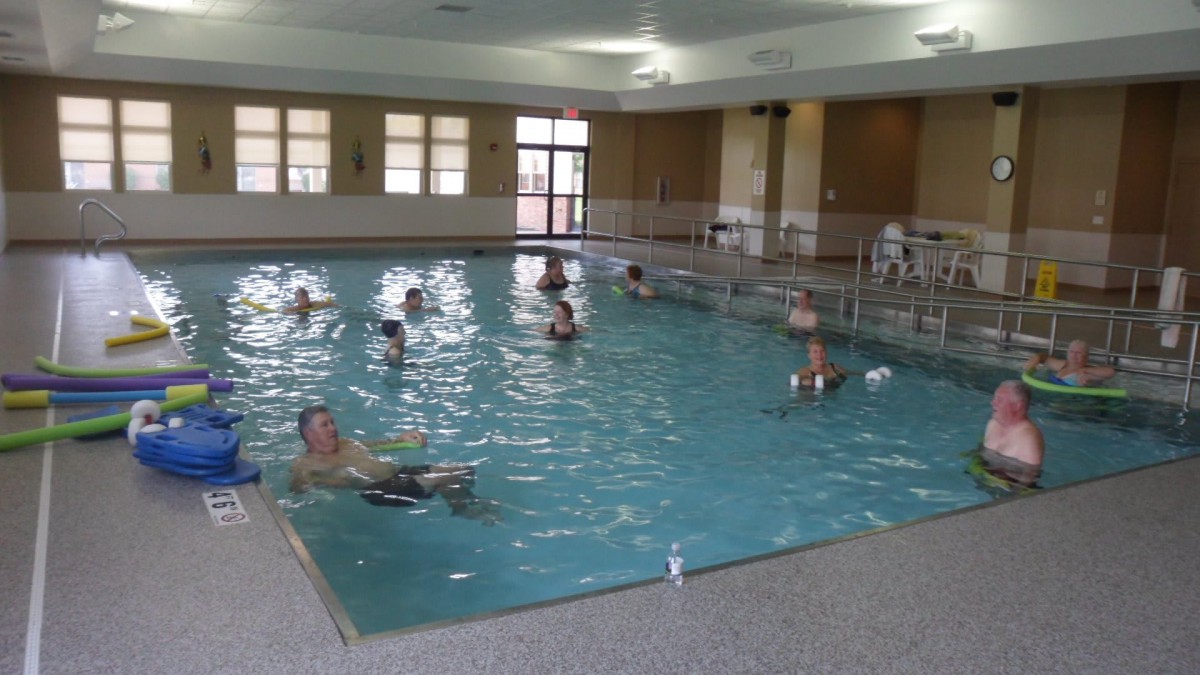 People enjoying a swim in an indoor pool.