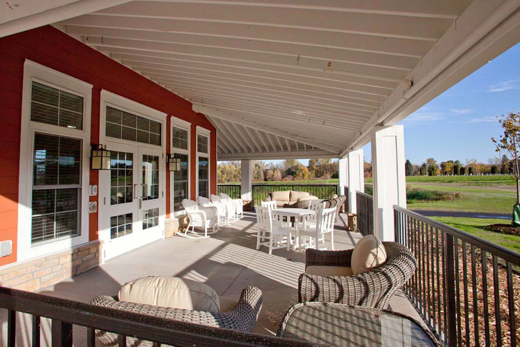 A cozy outdoor patio with comfortable seating and a serene view.