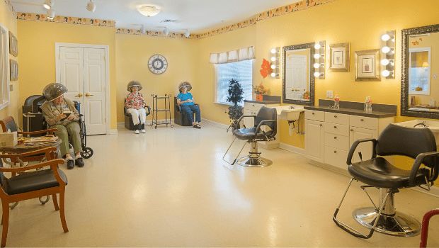 A well-lit hair salon with styling chairs and mirrors, featuring a bright and welcoming interior.
