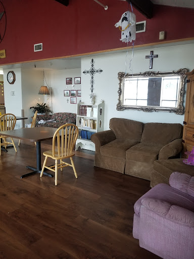 A cozy living room featuring a sofa, dining table, and various decorations.