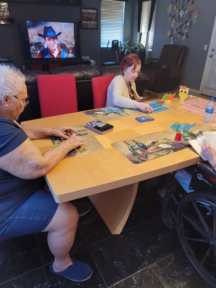A group of people enjoying a puzzle game around a table indoors.