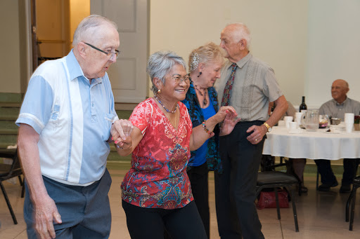 Seniors enjoying a lively dance together at a community event.