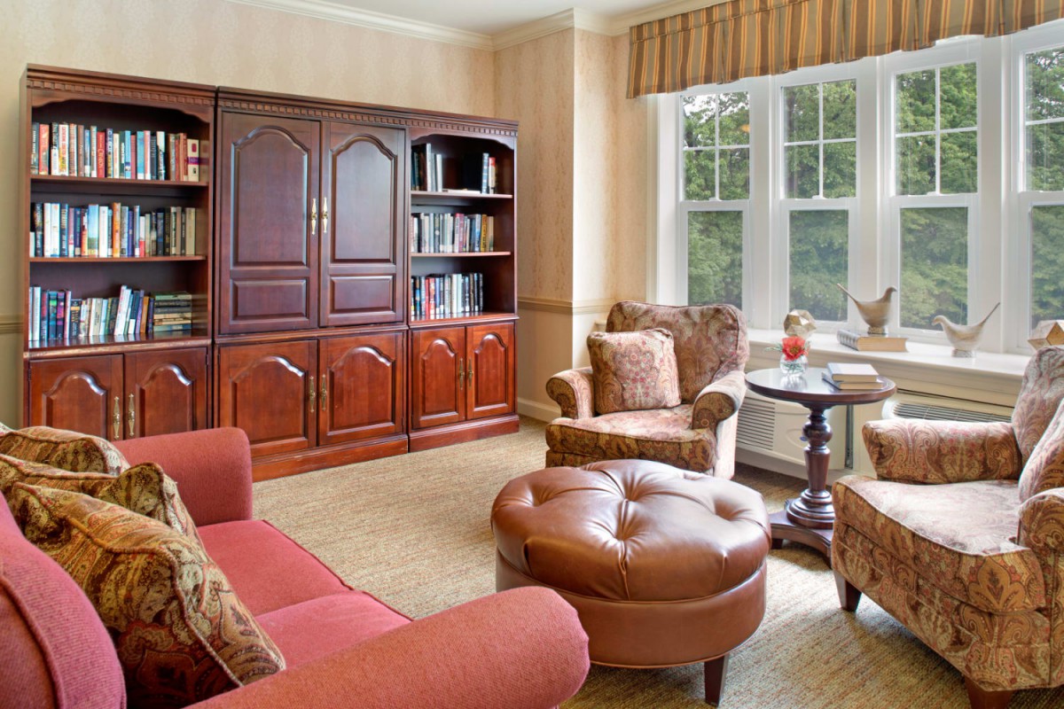 Cozy living room with comfortable seating and a bookshelf.