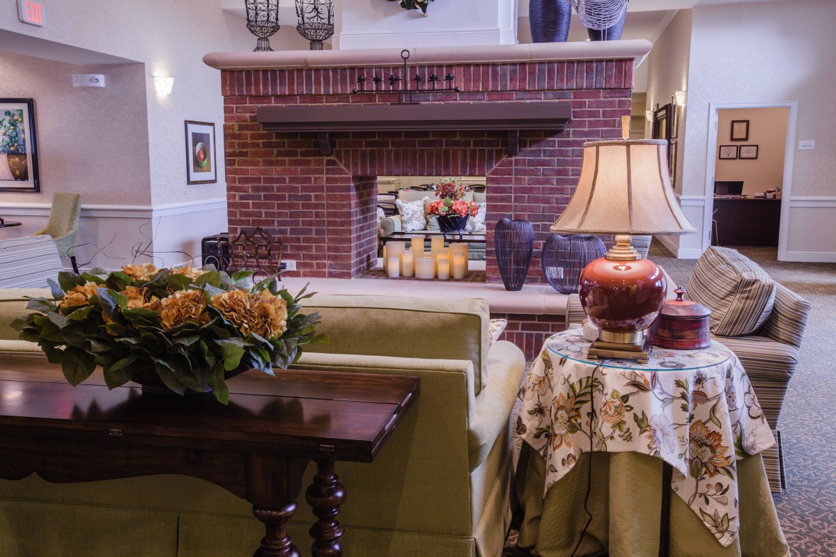 A cozy living room featuring a brick fireplace and elegant decor.