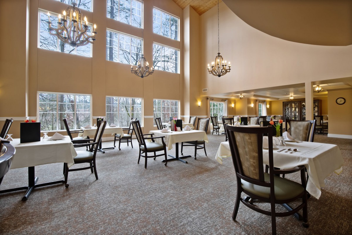 An elegant and spacious dining area with large windows and chandeliers.