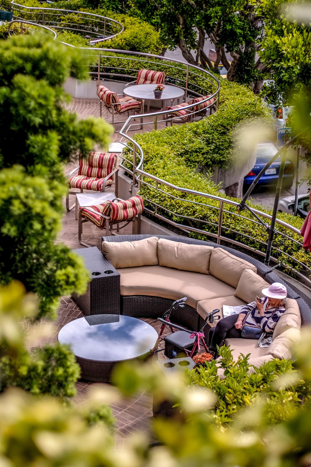 A cozy outdoor terrace with comfortable seating surrounded by lush greenery.