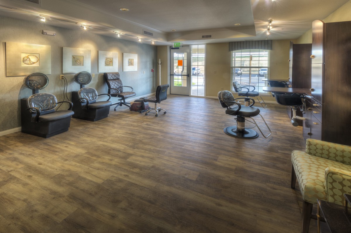 Spacious and modern salon interior with seating and stylish decor.