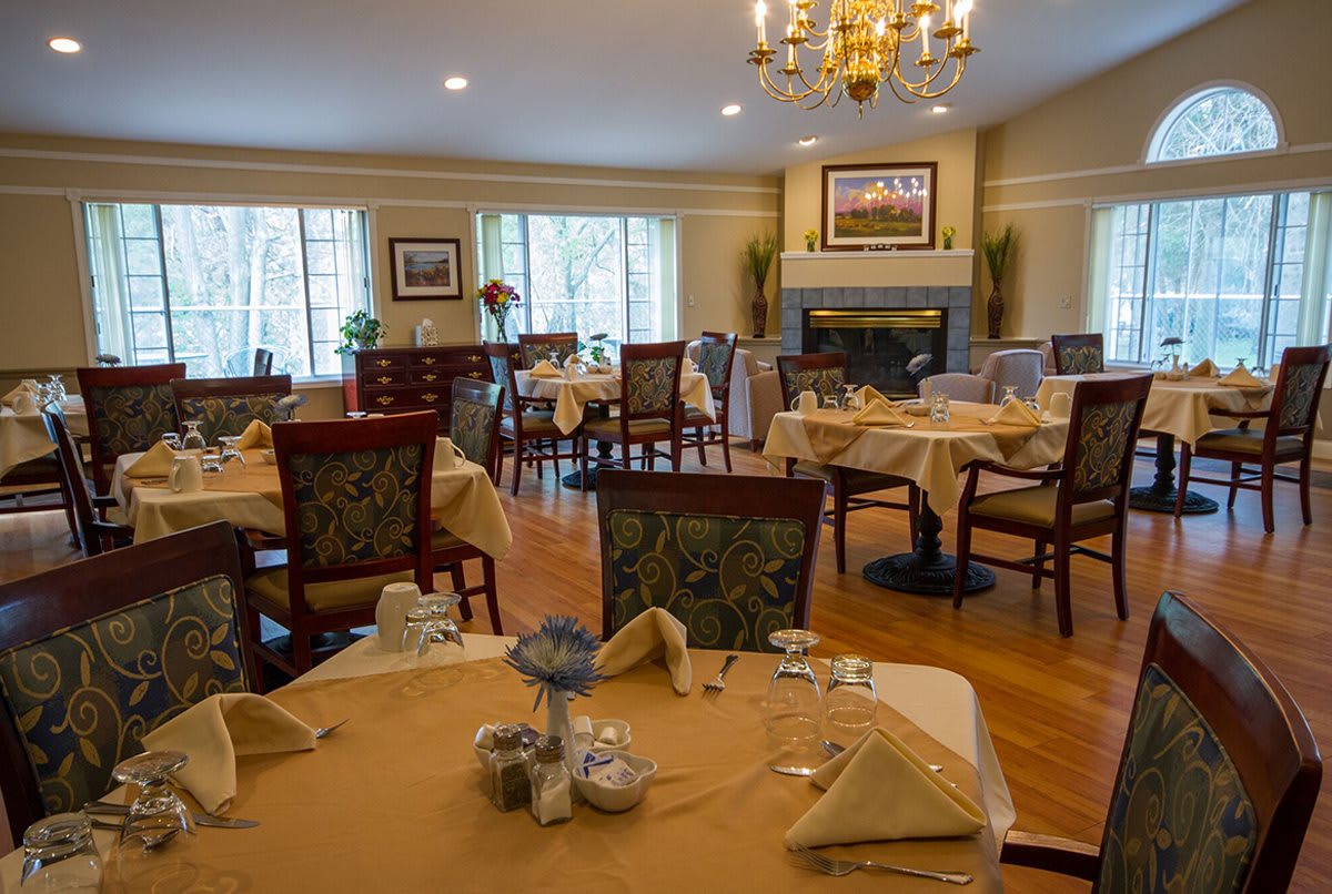 An elegant dining room with neatly arranged tables and chairs, showcasing a sophisticated atmosphere.