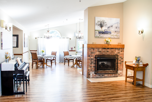 A bright and inviting open-concept living and dining area featuring a cozy fireplace and elegant furnishings.