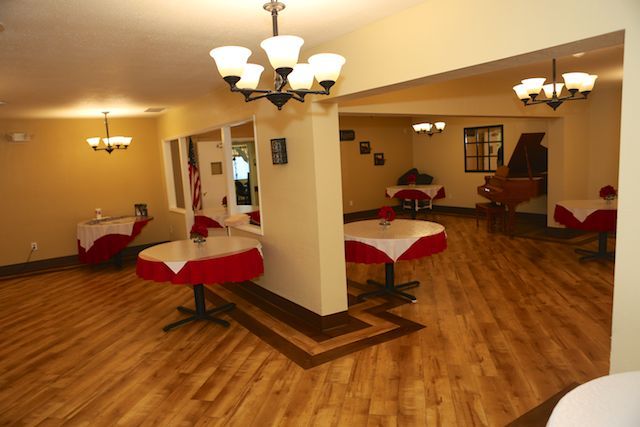 A cozy restaurant dining area with neatly arranged tables and warm lighting.