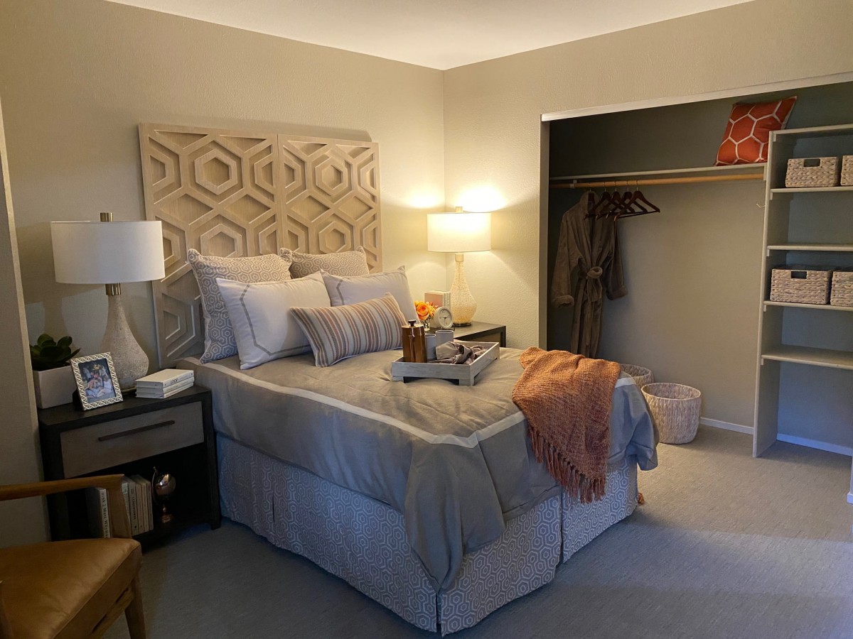 A cozy bedroom with tasteful decor and warm lighting.