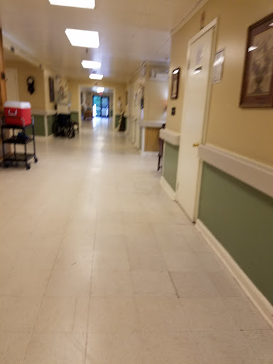 A view of a well-lit hallway in a healthcare facility.