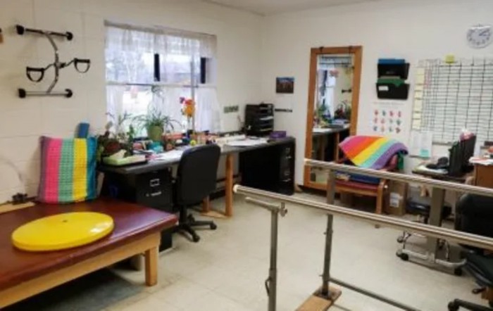 A rehabilitation clinic featuring equipment for physical therapy exercises.