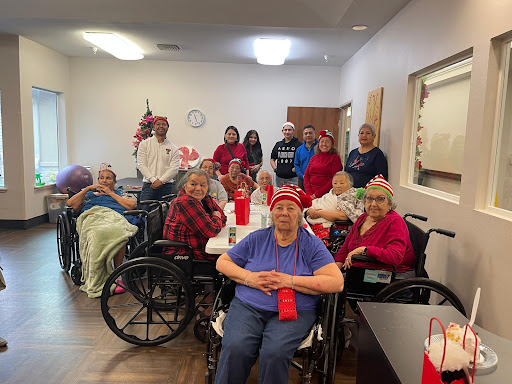 A joyful gathering of residents and staff celebrating together in a nursing home.