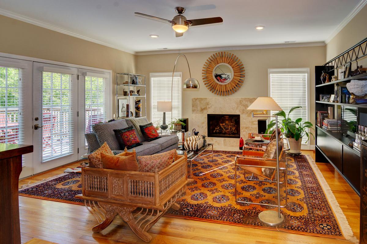 A cozy living room featuring a patterned rug, comfortable seating, and elegant decor.