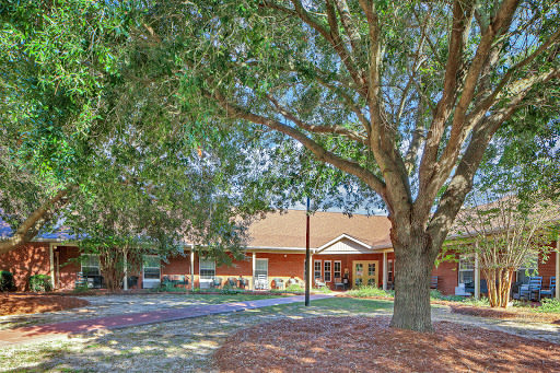 A scenic view of a house surrounded by trees and landscaping.