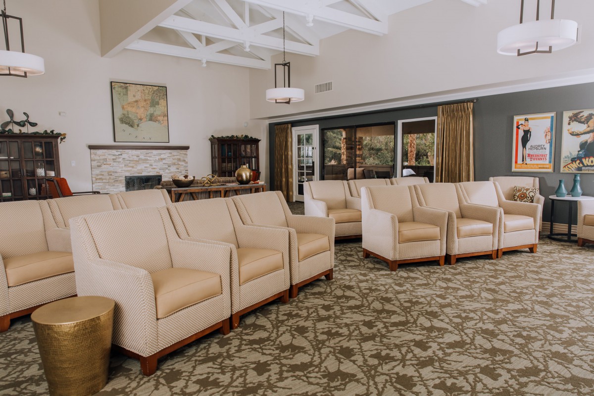 A spacious and elegantly decorated lobby with comfortable armchairs arranged neatly.