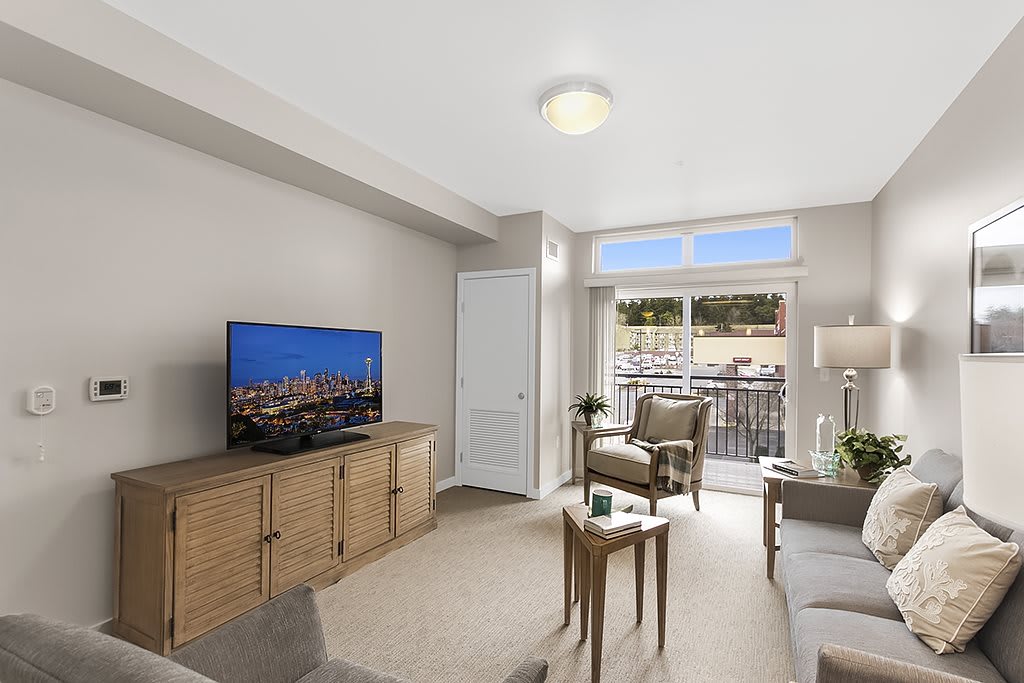 A comfortable living room with modern furnishings and a balcony view.