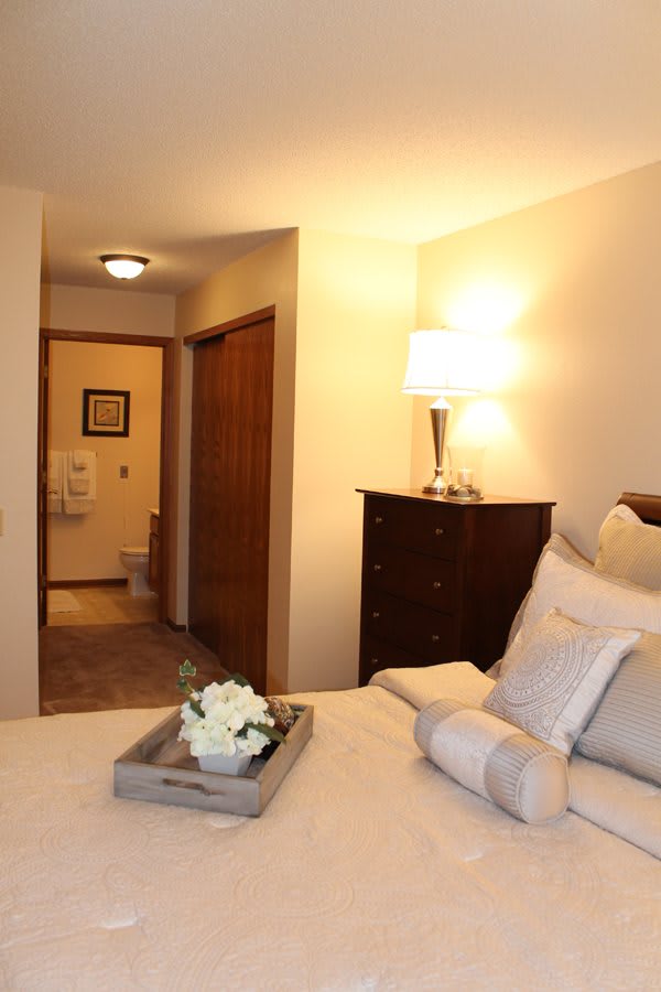 A cozy bedroom with warm lighting and elegant decor.