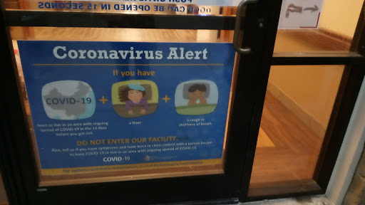 A sign displaying a coronavirus alert with guidelines for safety.