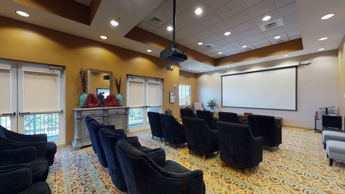 A cozy home theater setup with comfortable seating and a large screen for viewing.