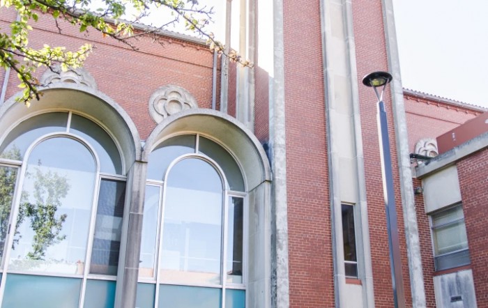 A close-up view of a brick building with arched windows and a modern design.