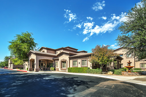 A beautifully designed residential building set against a clear blue sky.