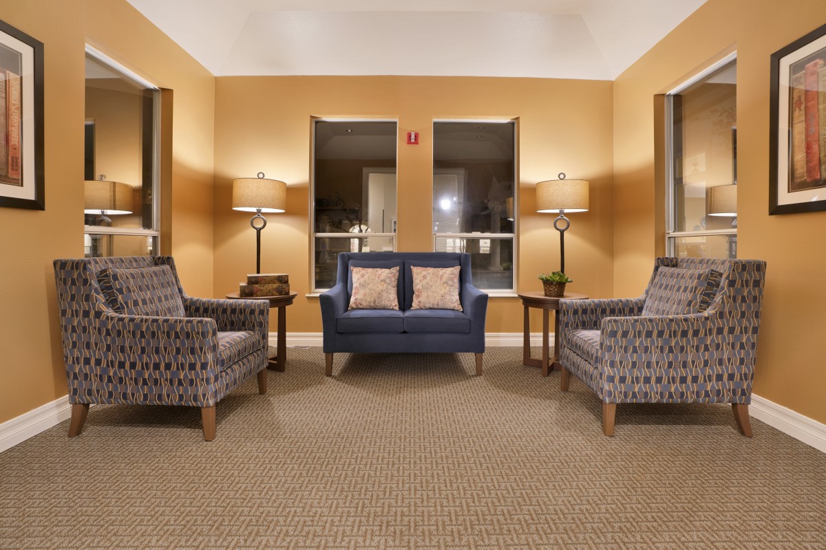 A cozy living room with a symmetrical arrangement of sofas and armchairs.