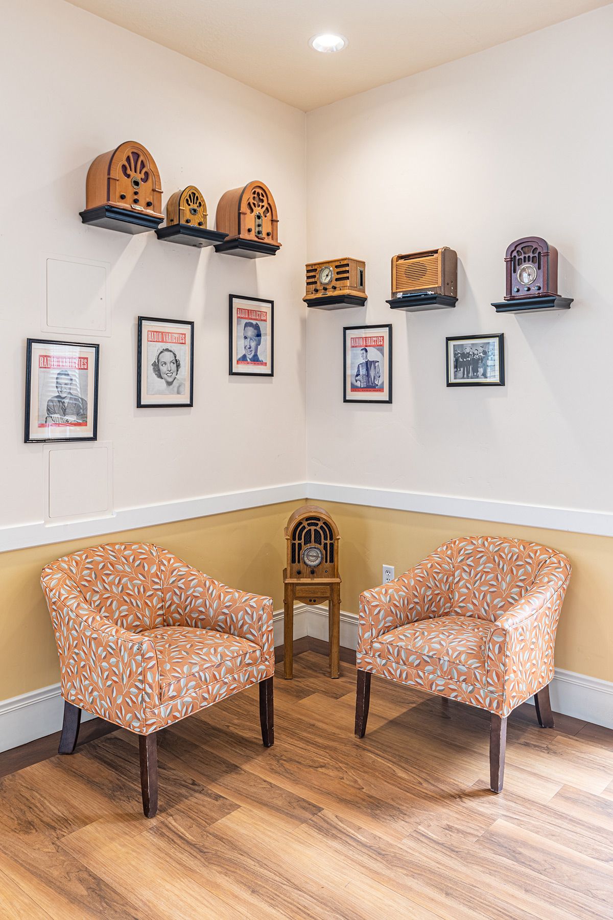 A cozy corner with vintage radios and framed art on display.