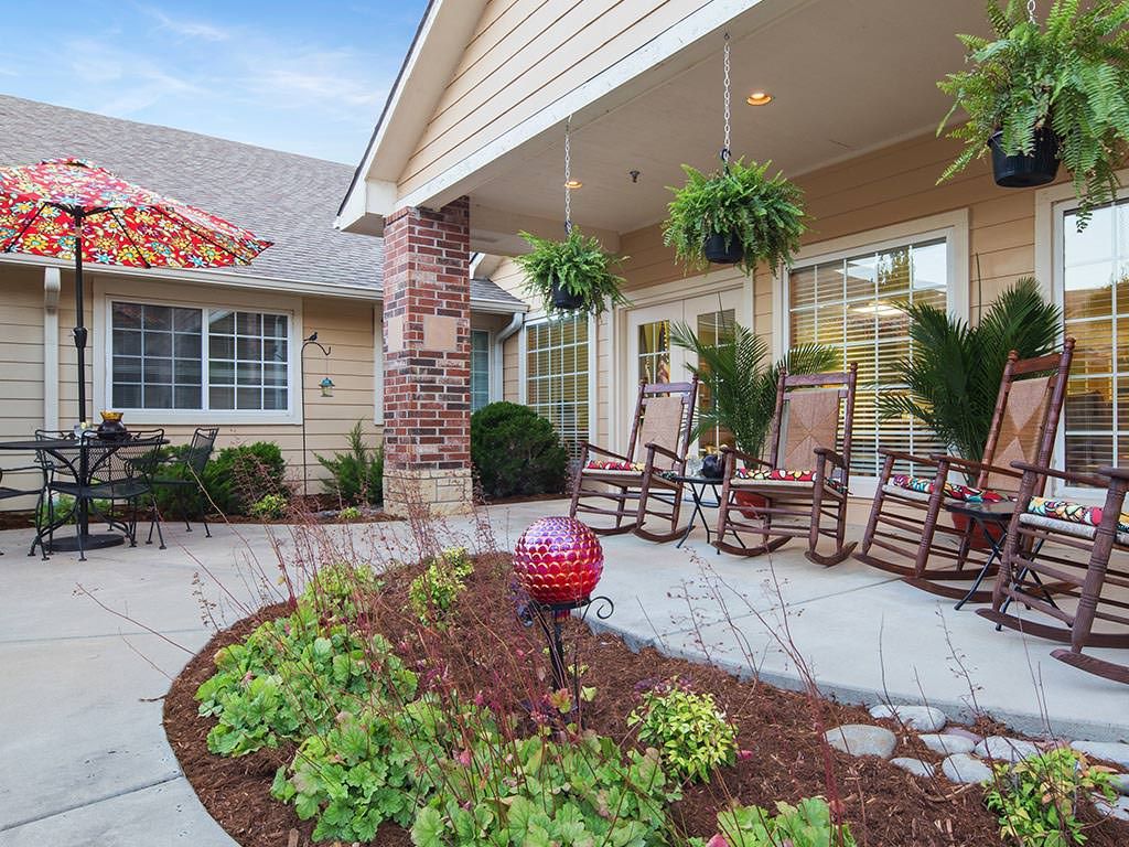 A welcoming porch with rocking chairs and lush plants, creating a cozy outdoor space.