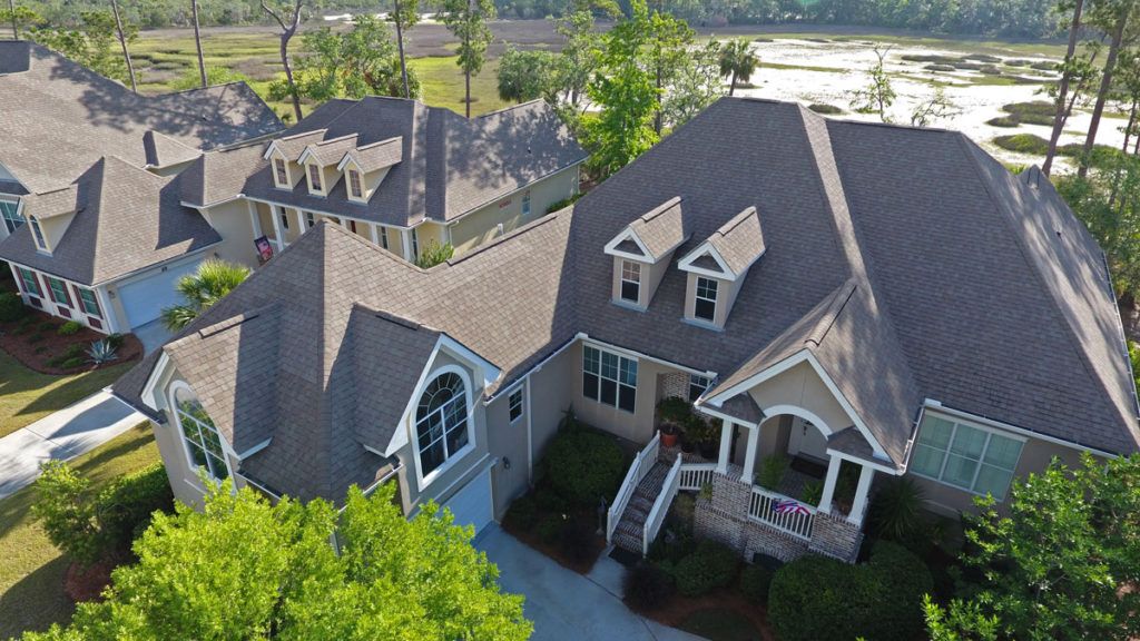 Aerial view of a residential house surrounded by trees.
