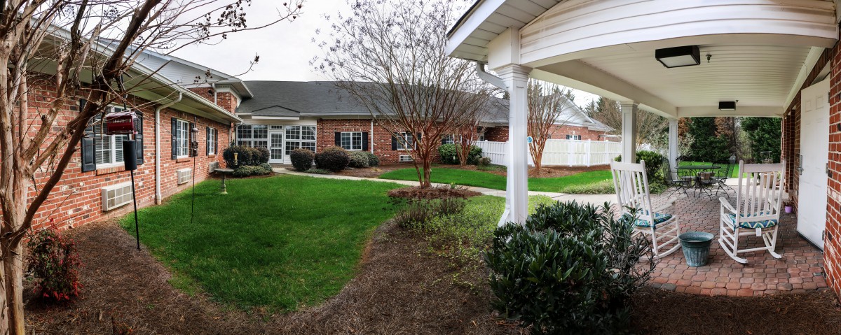 A landscaped garden area with a building and well-maintained greenery.