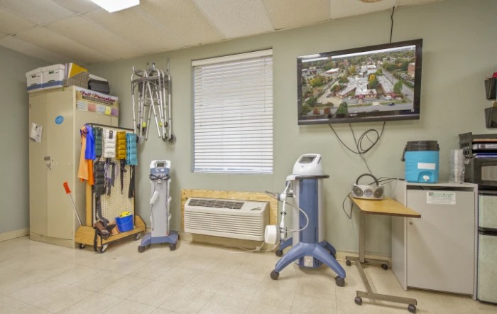 A medical treatment room equipped with various healthcare instruments and machines.