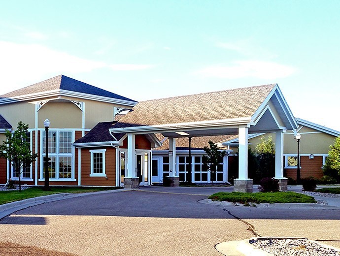 A building with a covered entrance and driveway.