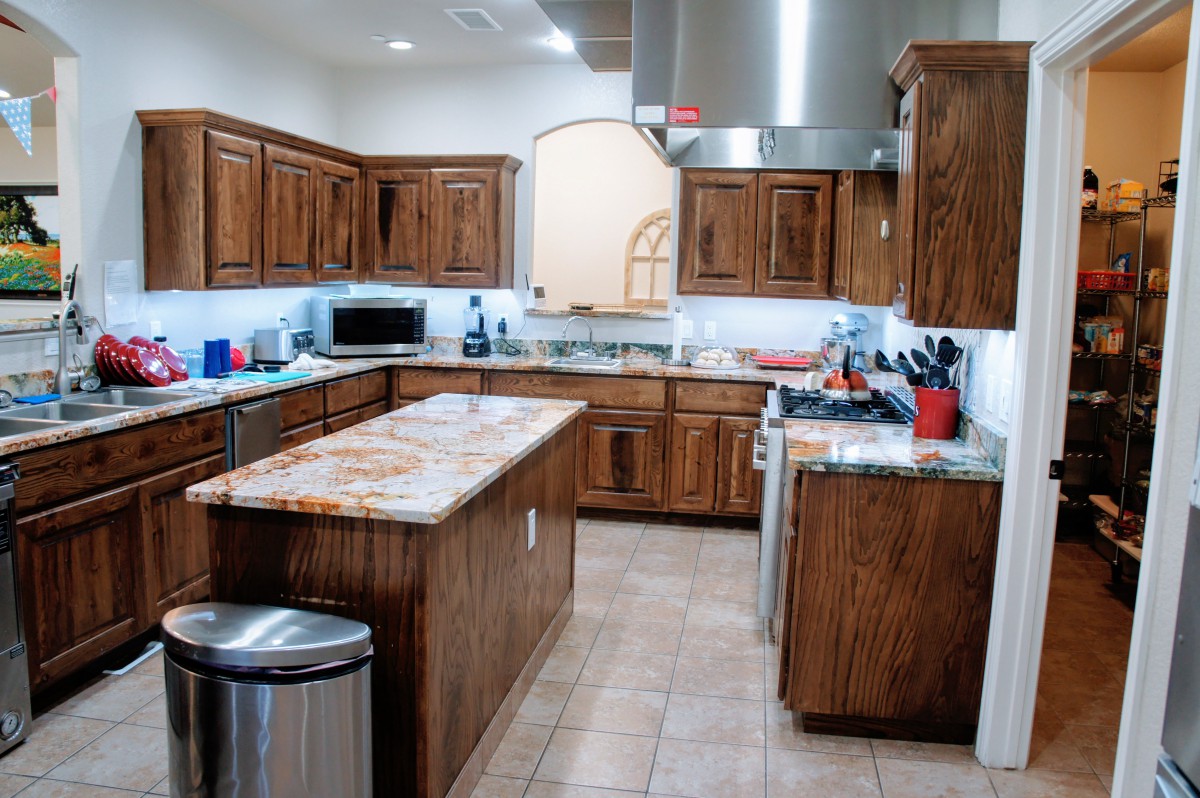 A spacious modern kitchen with wooden cabinets and a central island.
