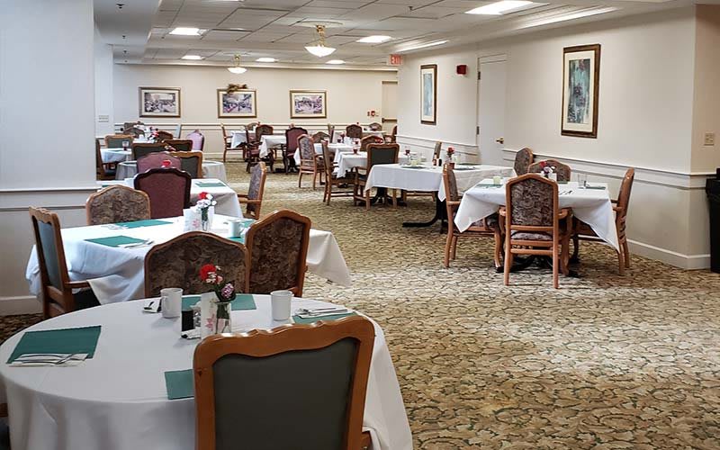 An elegant dining area with neatly arranged tables and chairs, ready for guests.
