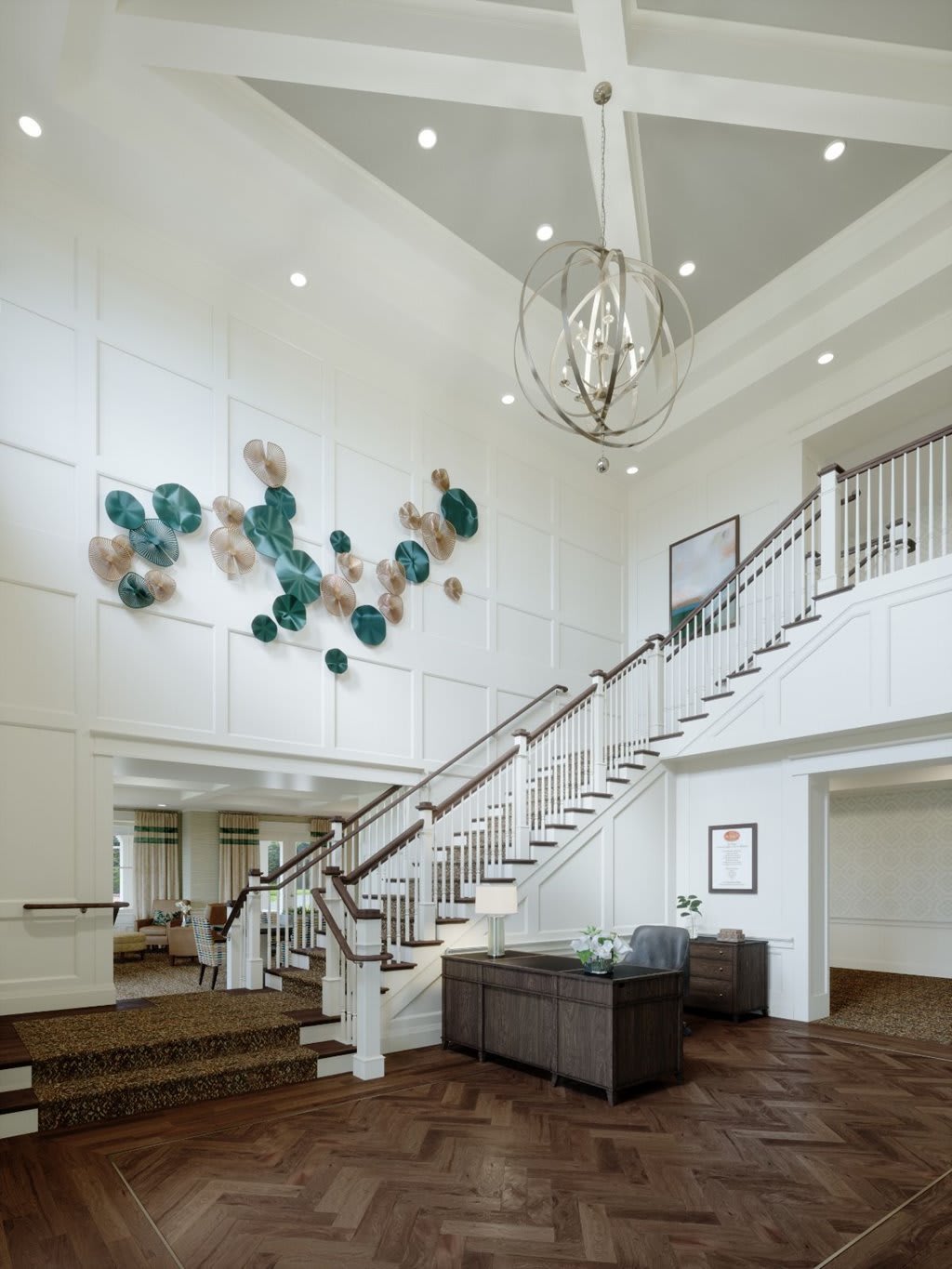 A modern interior with a grand staircase, stylish chandelier, and colorful wall art.
